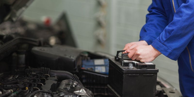 Mechanic changing a vehicle battery